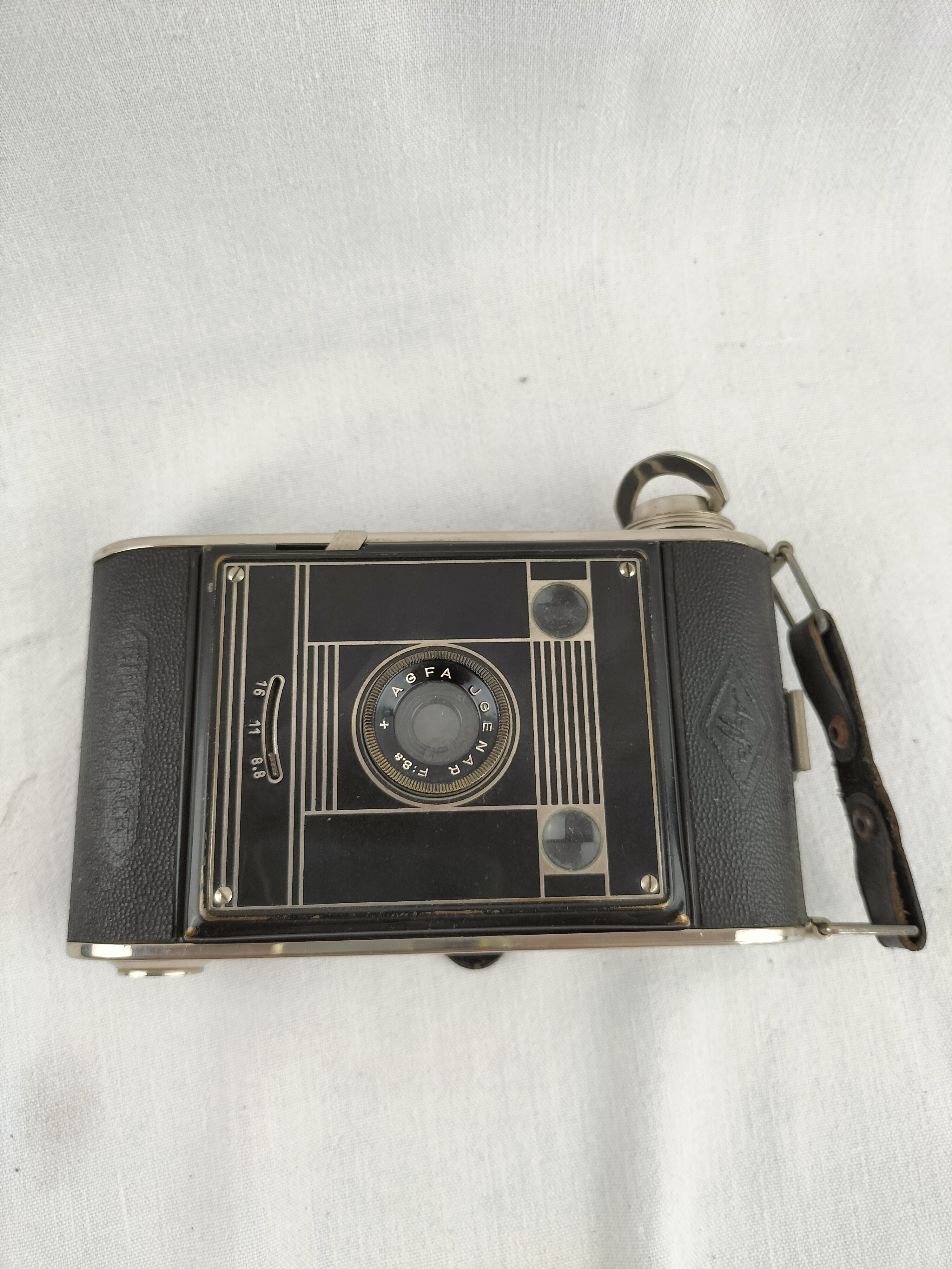 Voir photo 21 de Appareil photo ancien AGFA à soufflet avec étui d'origine – Charme vintage des années 1930-1950 Appareil photo ancien AGFA à soufflet avec étui d'origine – Charme vintage des années 1930-1950 bon état reconditionné photo 21