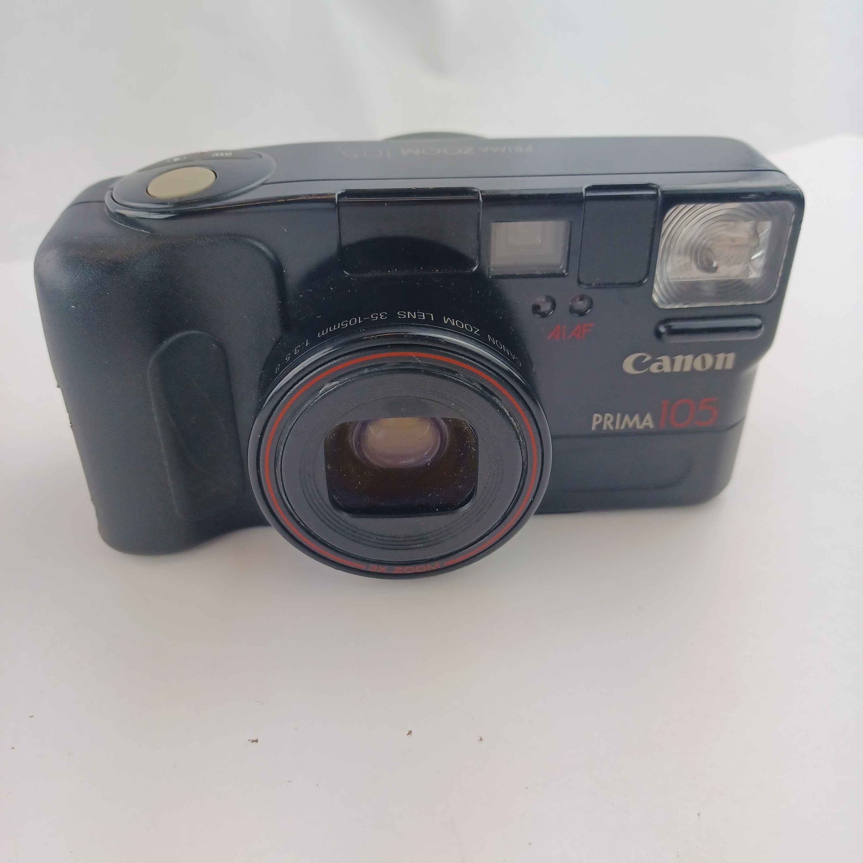 Voir photo 3 de Appareil photo Canon Prima 105 avec batterie lithium KL2CR5 sans chargeur, pellicule dedans, zoom 35-105, flash intégré, mode yeux rouges, retardateur et rafale, avec pochette et mode d'emploi Appareil photo Canon Prima 105 avec batterie lithium KL2CR5 sans chargeur, pellicule dedans, zoom 35-105, flash intégré, mode yeux rouges, retardateur et rafale, avec pochette et mode d'emploi Très bon état reconditionné photo 3
