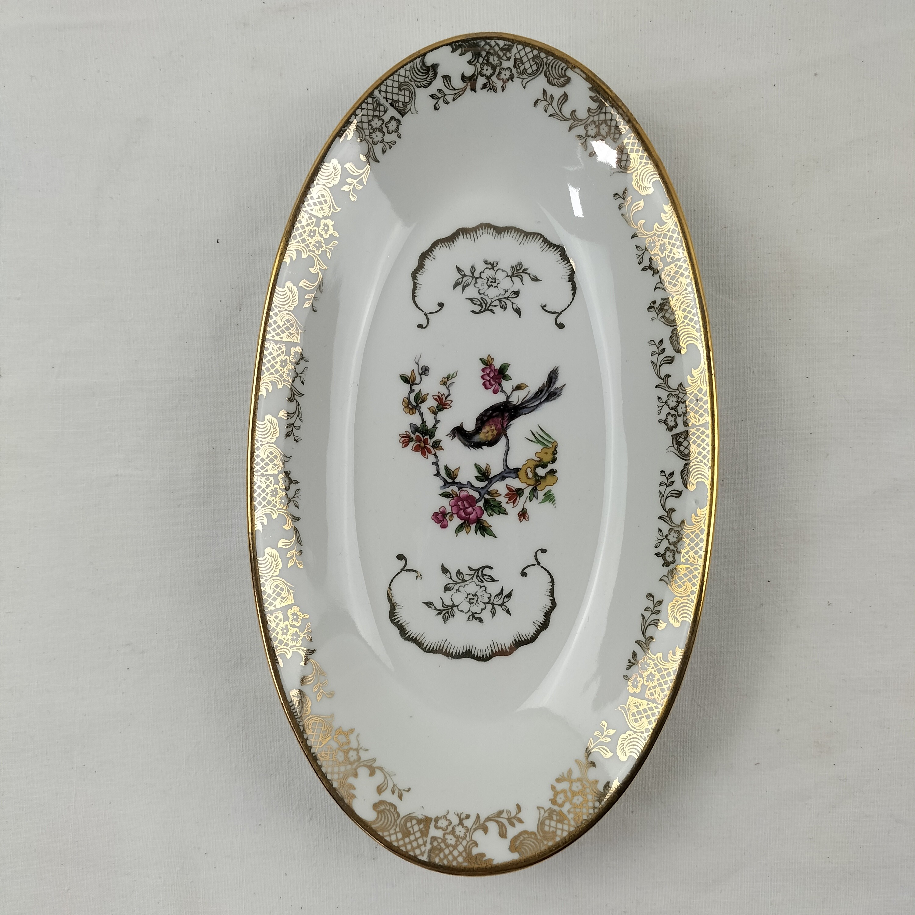 Voir photo 10 de Lot de plat ovale et saucière Oiseaux du Paradis "Porcelaine Véritable" Lot de plat ovale et saucière Oiseaux du Paradis "Porcelaine Véritable" Bon état reconditionné photo 10