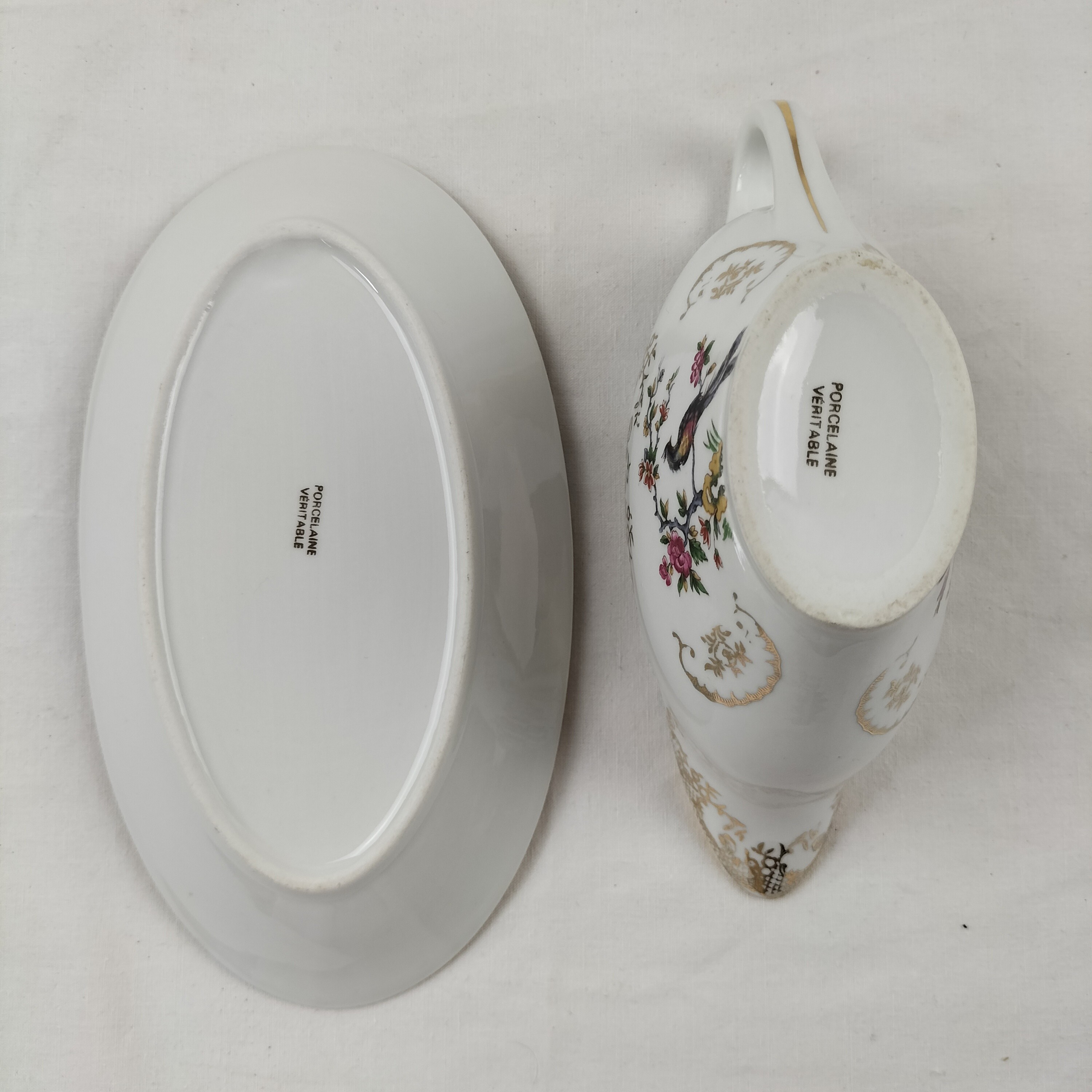 Voir photo 12 de Lot de plat ovale et saucière Oiseaux du Paradis "Porcelaine Véritable" Lot de plat ovale et saucière Oiseaux du Paradis "Porcelaine Véritable" Bon état reconditionné photo 12