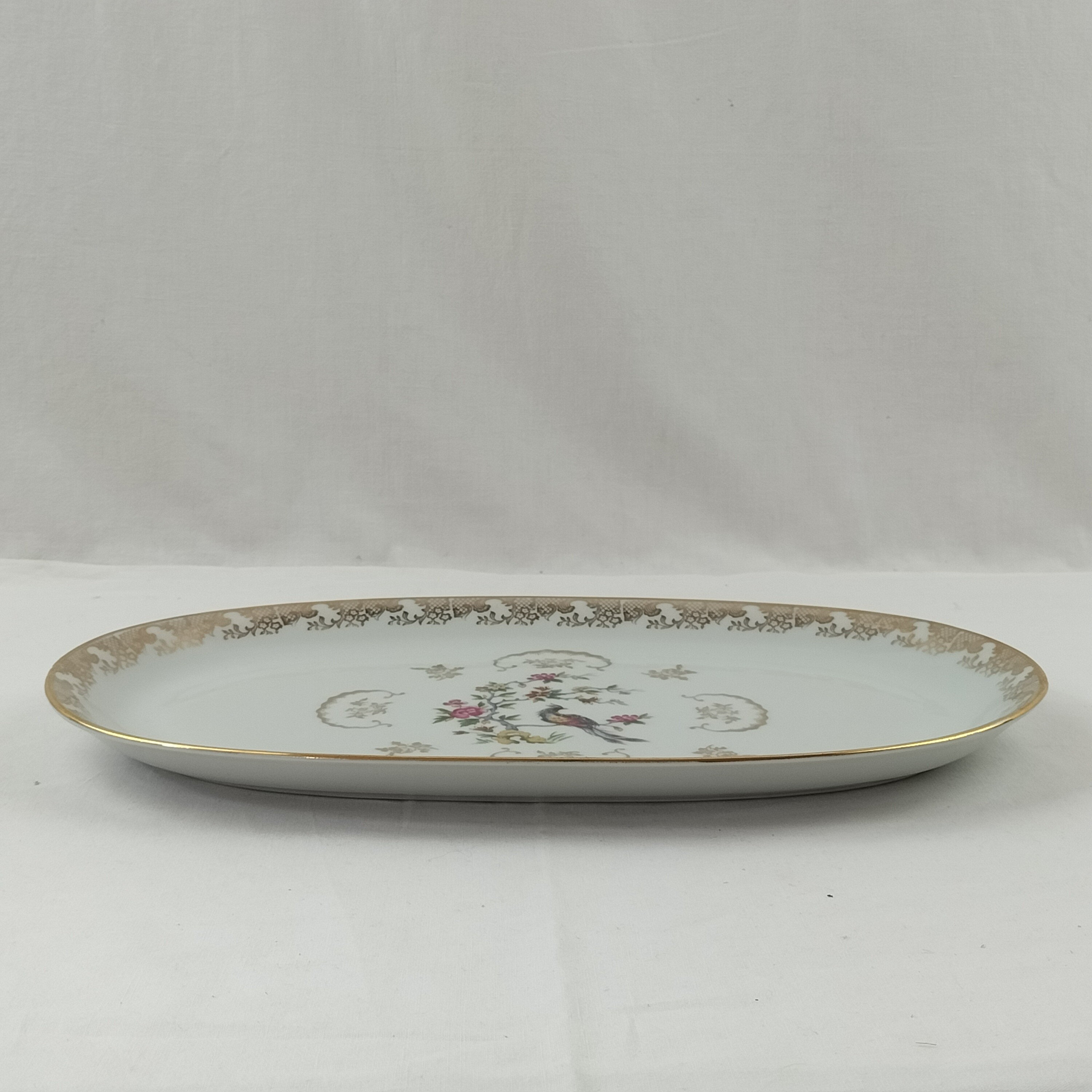 Voir photo 3 de Lot de plat ovale et saucière Oiseaux du Paradis "Porcelaine Véritable" Lot de plat ovale et saucière Oiseaux du Paradis "Porcelaine Véritable" Bon état reconditionné photo 3