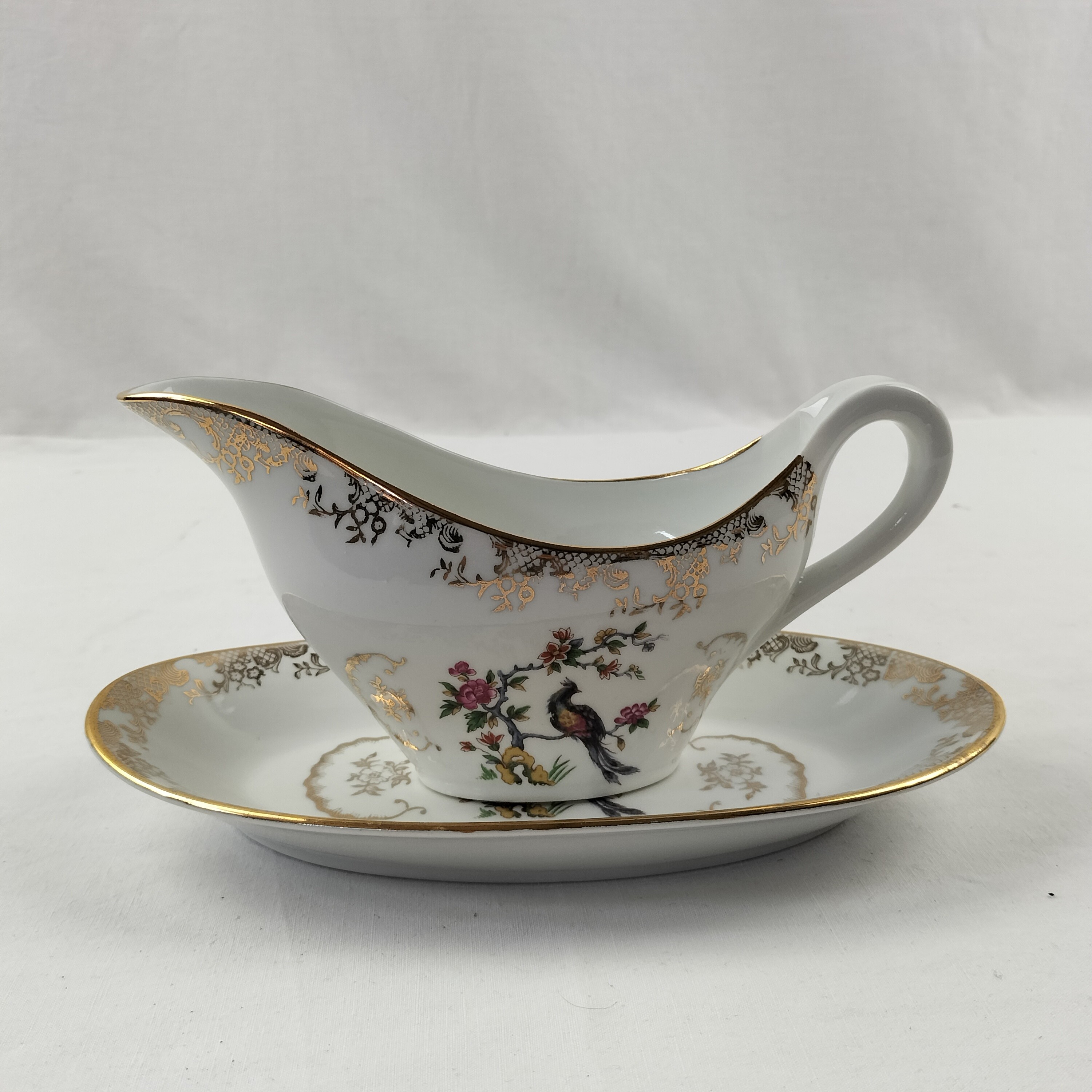 Voir photo 5 de Lot de plat ovale et saucière Oiseaux du Paradis "Porcelaine Véritable" Lot de plat ovale et saucière Oiseaux du Paradis "Porcelaine Véritable" Bon état reconditionné photo 5