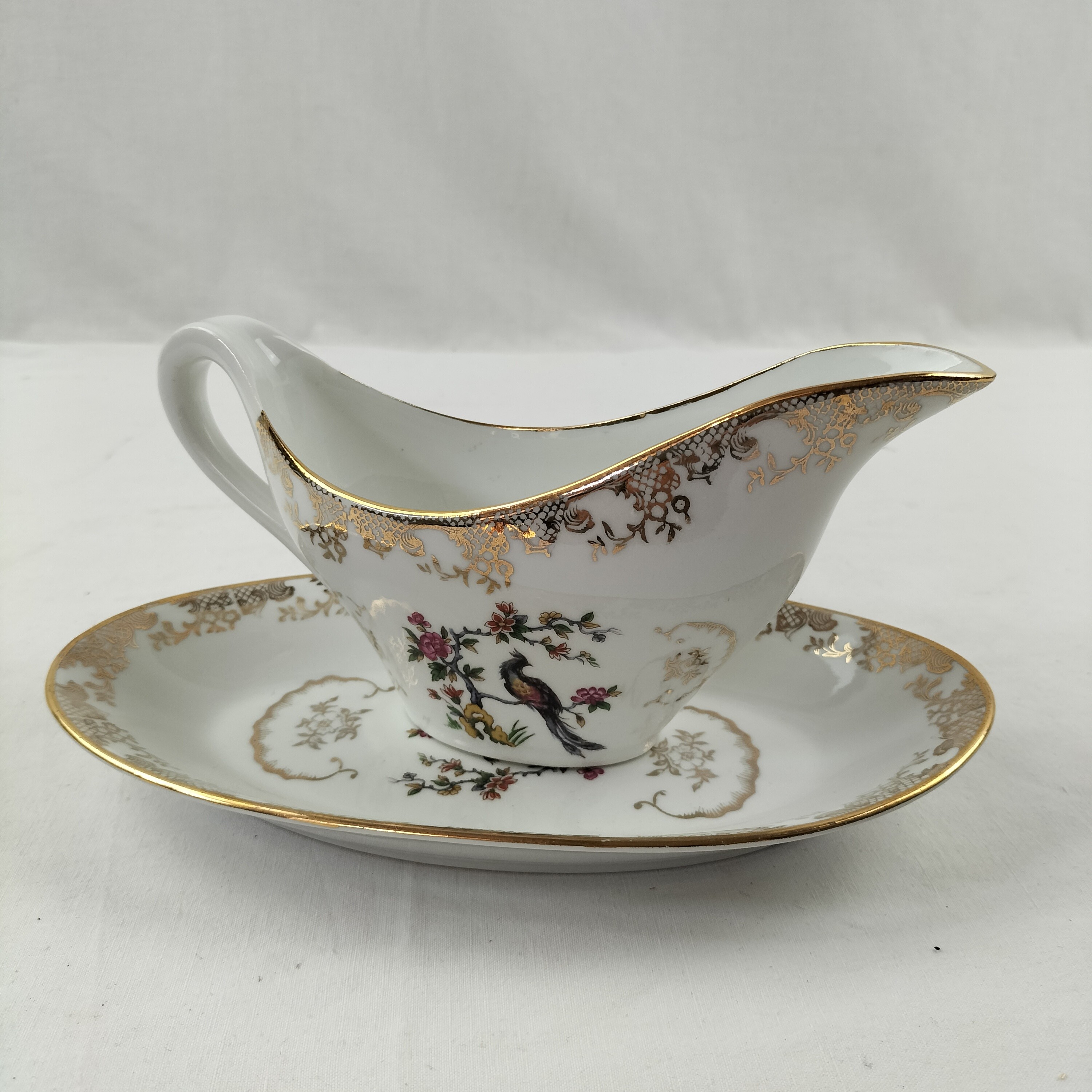 Voir photo 6 de Lot de plat ovale et saucière Oiseaux du Paradis "Porcelaine Véritable" Lot de plat ovale et saucière Oiseaux du Paradis "Porcelaine Véritable" Bon état reconditionné photo 6