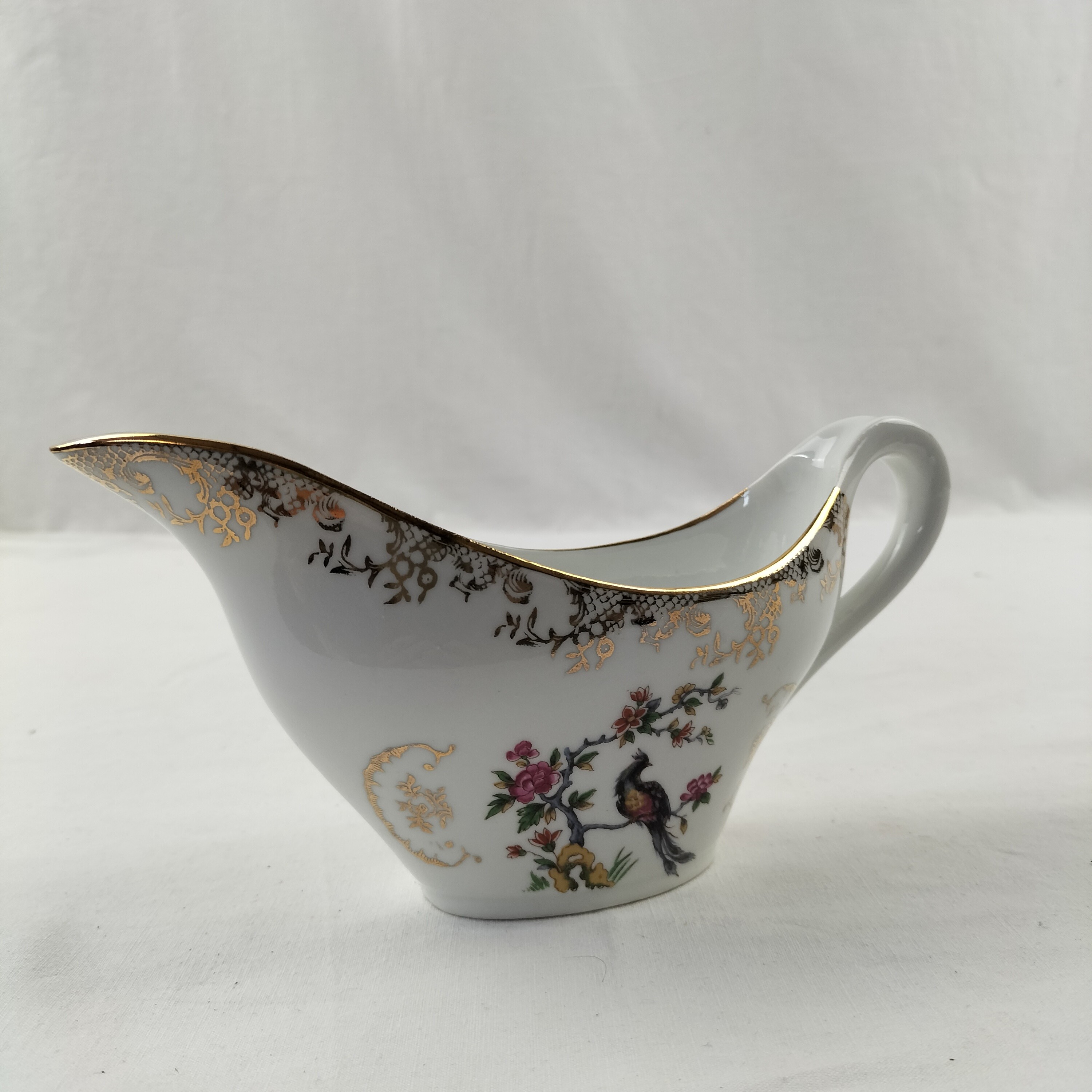 Voir photo 7 de Lot de plat ovale et saucière Oiseaux du Paradis "Porcelaine Véritable" Lot de plat ovale et saucière Oiseaux du Paradis "Porcelaine Véritable" Bon état reconditionné photo 7