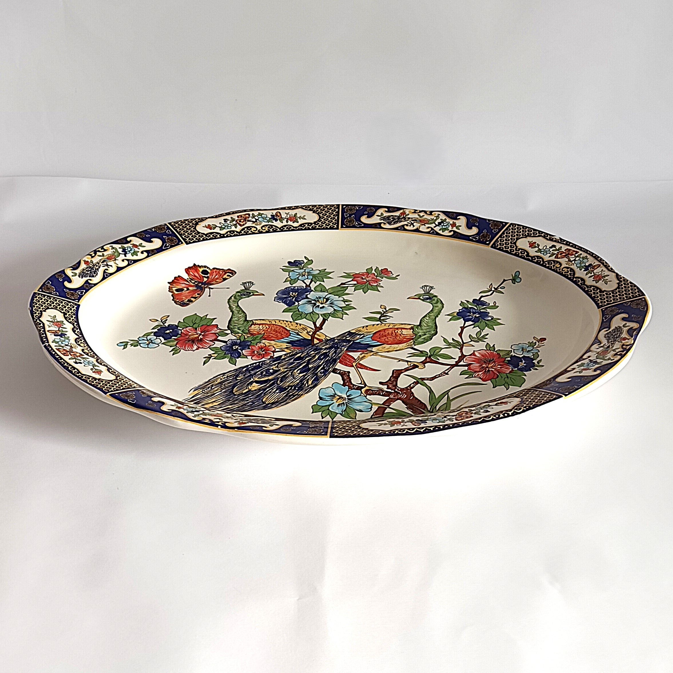 Voir photo 6 de Plat ovale en faïence décor paons et fleurs – 47,5 x 35,5 cm Plat ovale en faïence décor paons et fleurs – 47,5 x 35,5 cm Bon état reconditionné photo 6