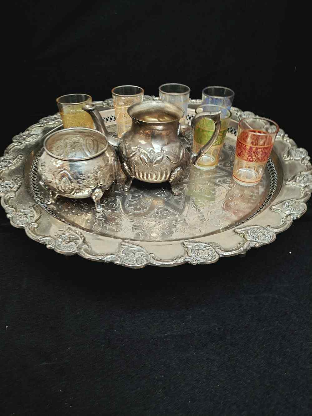 Voir photo 2 de Service à thé marocain, table à pied, 6 verres à thé, théière et sucrier en métal argenté. Service à thé marocain, table à pied, 6 verres à thé, théière et sucrier en métal argenté. Bon état reconditionné photo 2