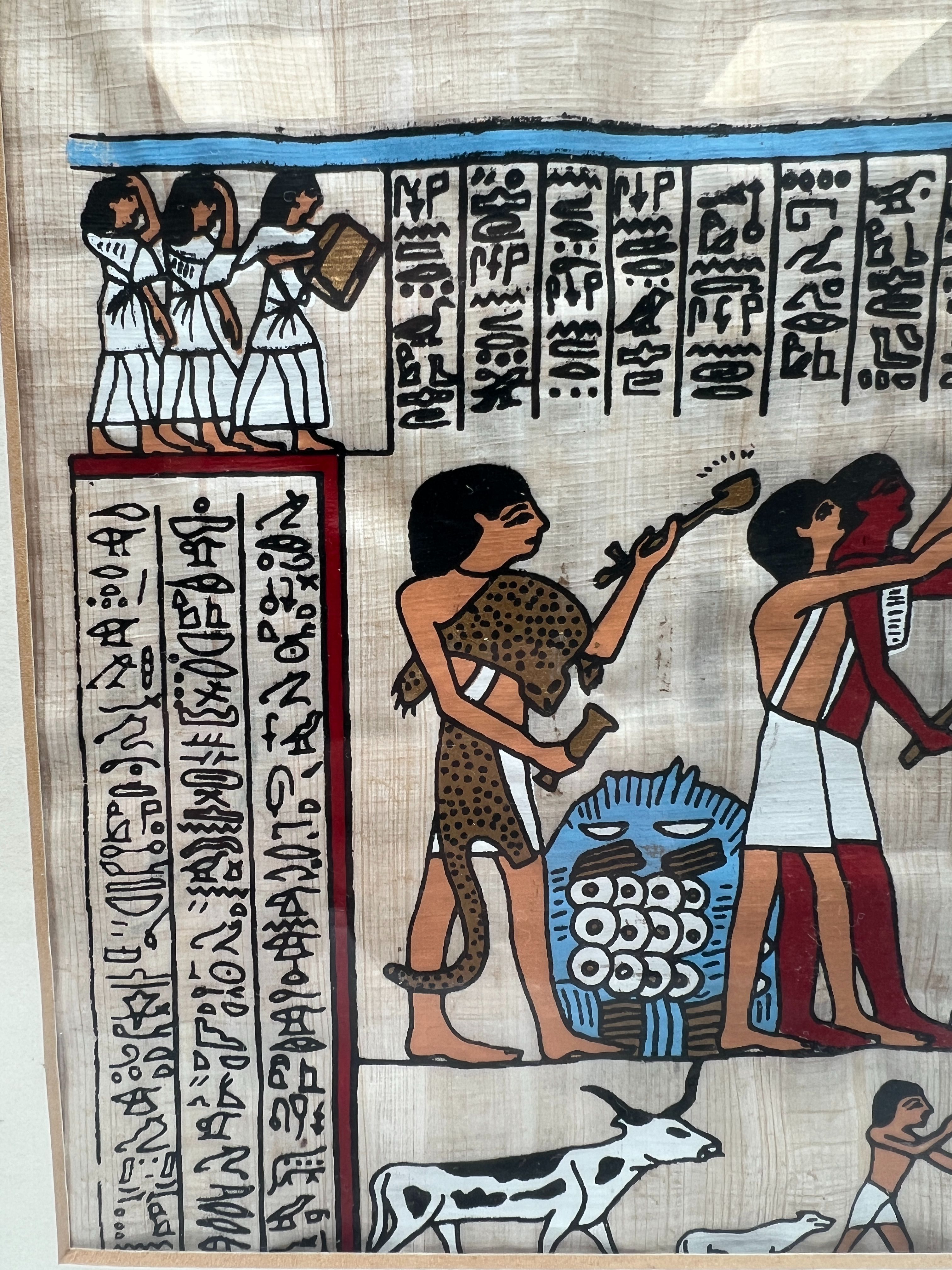 Voir photo 2 de Tableau parchemin égyptien en papyrus cadre plastique doré. Scène d'offrandes. Tableau parchemin égyptien en papyrus cadre plastique doré. Scène d'offrandes. Très bon état reconditionné photo 2